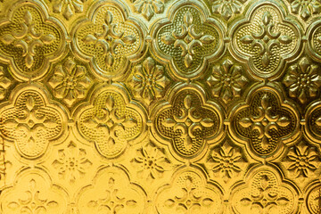 Golden ornamental metal texture with intricate floral patterns