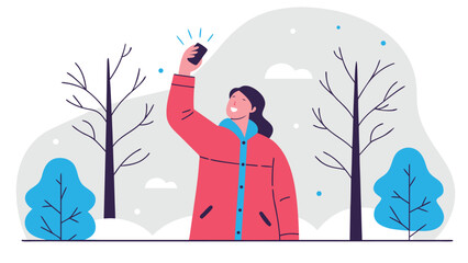 Happy woman holding her smartphone high to catch a better signal in a snowy winter park with bare trees.