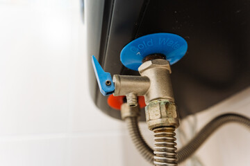 Shutoff Valve And Brass Connector Shown. Closeup Revealing Detailed Plumbing Components And Textures. Detailed View Of Shutoff Valve Connected With Braided Hose And Metallic Fittings