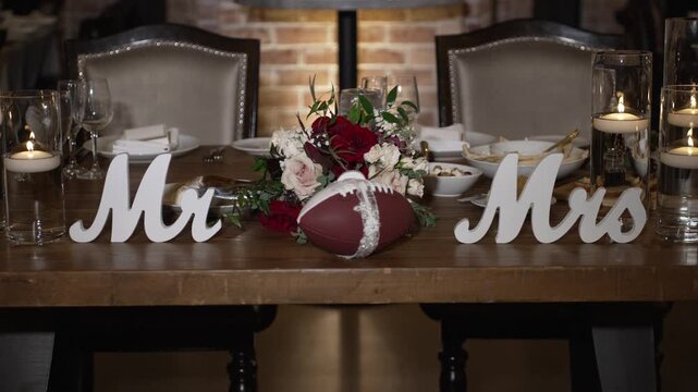 Atmospheric wedding venue setup with elegant table settings, glowing candles, and decorative lanterns creating a warm and romantic ambiance. Beautiful reception d cor prepared for guests, cozy evening