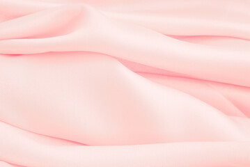Pink wrinkled fabric background. Close up Satin cloth texture