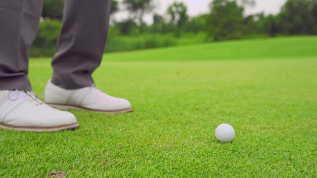 Close up of professional golfer swinging club on a scenic golf course.