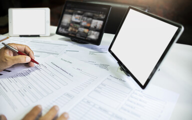 Obraz premium close up shot, asian man start e-commerce business checking document, order form working online with laptop, tablet via modern communication technology