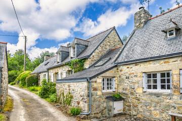 Road through a village in the French countryside with old idyllic stone houses © Lars Johansson