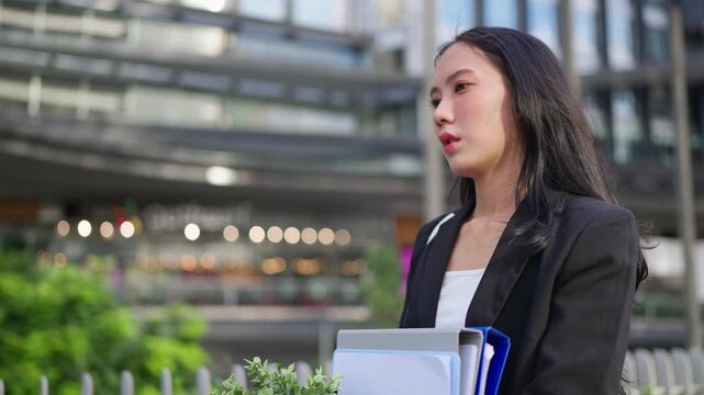 Asian businesswoman feeling sad and discouraged after losing her job. 