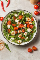 Salad with arugula, cherry tomatoes and mozzarella