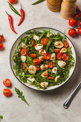 Salad with arugula, cherry tomatoes and mozzarella