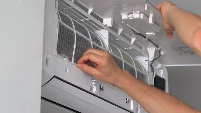 Repairmans hands of change cleaning filter in air conditioner. Air conditioning maintenance. Purification and repair of cooling system