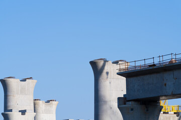 Obraz premium Concrete Bridge Piers Under Construction Against Blue Sky