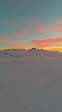 Dramatic Fiery Sunset Over Snowy Mountain Landscape &ndash; Aerial Drone View, Mount Aragats is visible from the valley