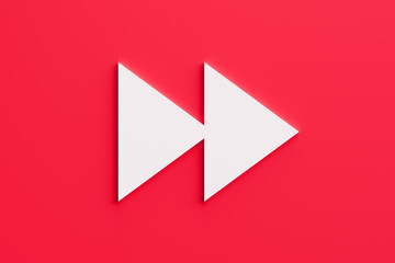 White fast forward arrows on red background