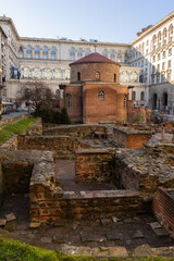 Fototapeta premium Red brick rotunda of St. George, Constantine Quarter, Sofia. Religious building within archaeological complex, ruins of ancient buildings and remains of paved street from Roman Empire..