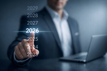 Fototapeta premium Businessman pointing at the year 2026 on a digital timeline for future business strategy and planning