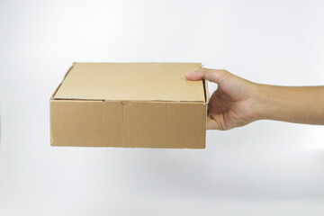 close up of a man's hand giving a package isolated on a white background. a man's hand holding a plain brown box