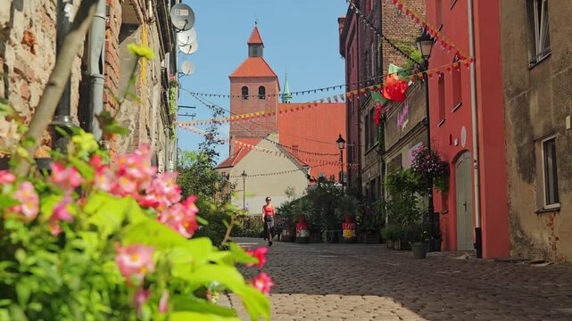 Peaceful slow motion view of woman walking through vibrant old Grudziadz