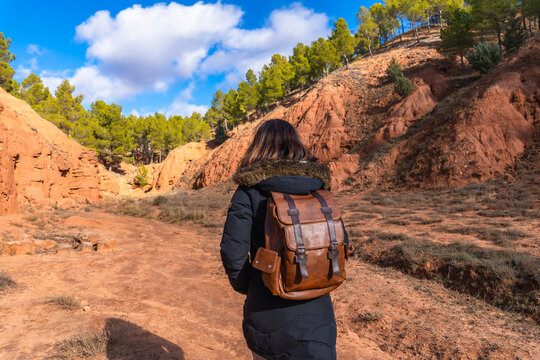 Woman hiking through las arcillas natural park exploring red clay canyon