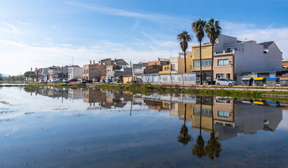 El palmar fishing village reflecting on flooded rice paddies