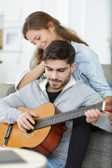 Fototapeta premium lady listening to her boyfriend play the guitar