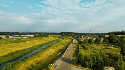 Fototapeta premium Paved cycling trail through green countryside