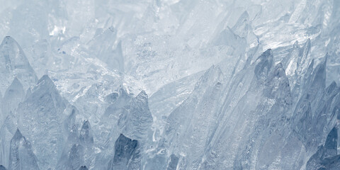 Closeup of sharp translucent ice crystals as natural frozen texture in cold winter banner. Abstract...