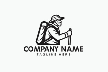 Fototapeta premium Mountain man logo showing a monochrome figure with hat and mountain background holding staff