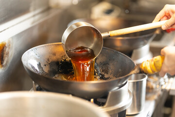 Chef Preparing Ramen in Japanese Noodle Shop with Steam Rising