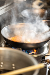 Chef Preparing Ramen in Japanese Noodle Shop with Steam Rising