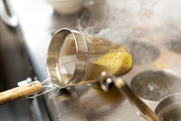 Chef Preparing Ramen in Japanese Noodle Shop with Steam Rising
