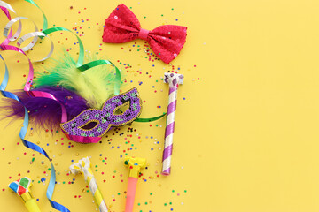 masquerade celebration concept over yellow background