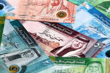 Jordanian dinar money bills pile on table. Jordan banknotes of JOD currency close up.