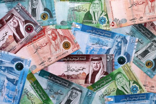 Jordanian dinar money bills pile on table. Jordan banknotes of JOD currency close up.
