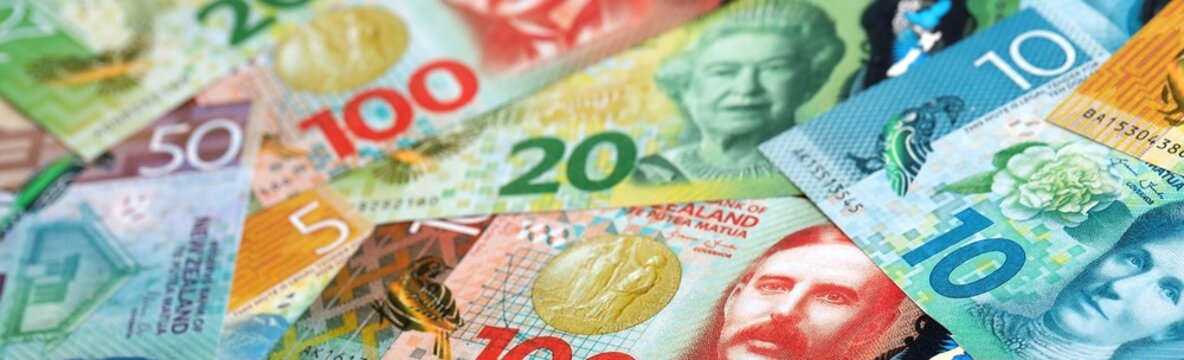New Zealand dollar money bills pile on table. New Zealand banknotes of NZD currency close up.