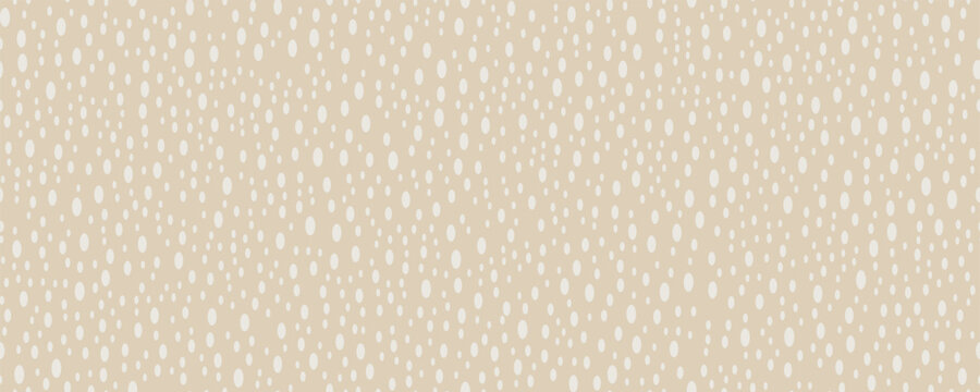 Seamless abstract halftone pattern with scattered oval dots in soft beige and white tones. Light airy textile background.