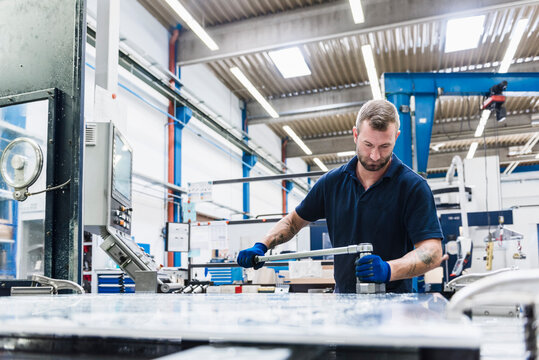 Man working on machine in industrial factory