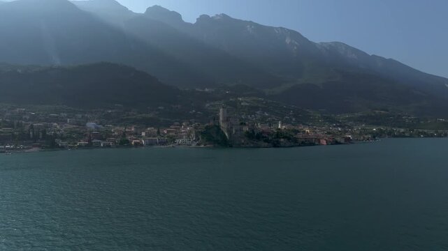 Europe Italy Lake Garda Malcesine Castle Aerial Drone View above water towards the Castle 4K 60fps
