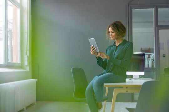 Young businesswoman using digital tablet in office