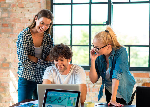 Young professionals working together in start up company, developing a business plan