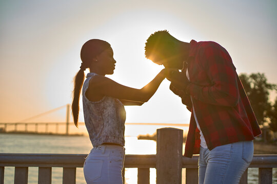 Young couple holding hands at sunset