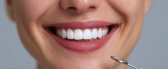 Fototapeta premium A patient smiles during a dental examination highlighting healthy teeth and effective dental care.