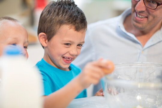 Boy helping to cook in kitchen