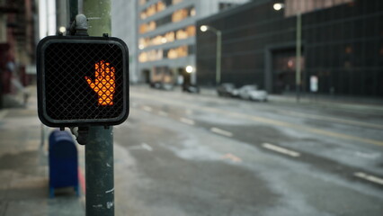 A glowing hand signal stands at a city intersection. The background reveals empty streets lined with tall buildings. Morning light begins to illuminate the urban scene. © icetray