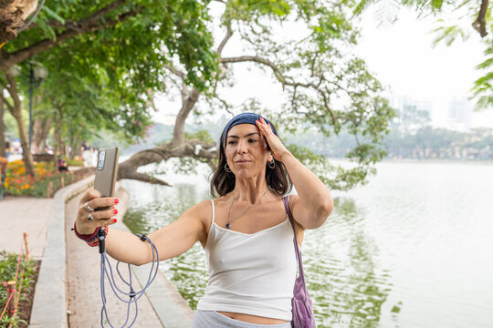 Woman capturing moments with her phone in quan hoan kiem, hanoi, vietnam