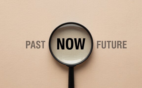 Time management concept with magnifying glass on past now future
