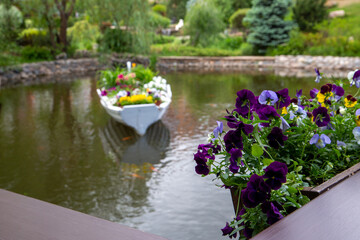 A pond decorated with flowers in a landscape park. Resting place, public park in the city.