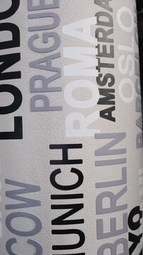 a modern wallpaper design characterized by an urban typography pattern of world city names