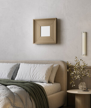 Cozy beige bedroom interior with framed mockup and soft bedding