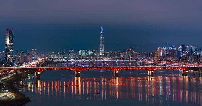 Dynamic drone hyperlapse zooming into Seongsu Bridge with night traffic lights and Lotte Tower view
