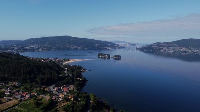 4K Cinematic drone footage of the R&iacute;a de Vigo estuary in Galicia, Spain, featuring the Rande Bridge and the deep Atlantic blue water entering the lush coastline.