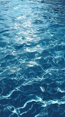 Fototapeta premium Shimmering blue water surface with sun reflections and ripples