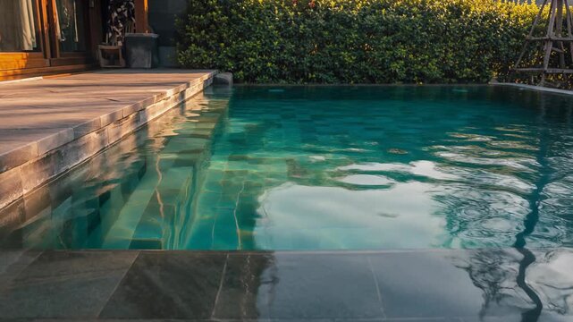 Tropical swimming pool water, resort patio, lush green